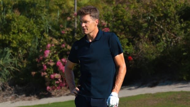 Tom Brady in a photo shoot on a golf course.